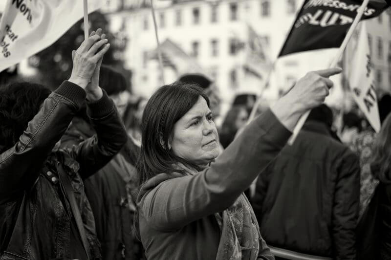 "Lisbon, Portugal - January 26, 2013: A woman waves a flag during a protest rally in Lisbon downtown, against the Education policy of the government."