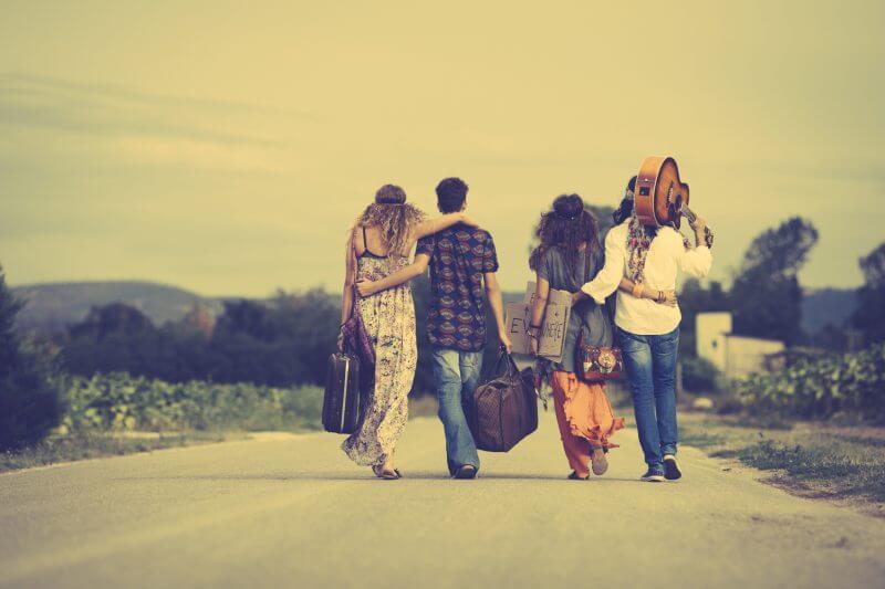 Group of hippie friends walk away. Vintage style
